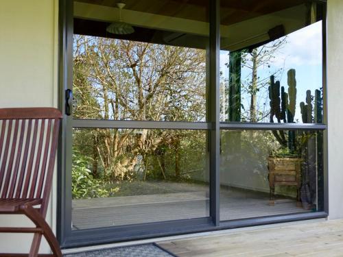 a sliding glass door with a view of a garden at Wharepuke Subtropical Accommodation in Kerikeri