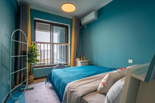 En eller flere senge i et værelse på Zhengzhou Jinshui·Province Sport Centre· Locals Apartment 00172870