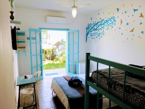 a bedroom with a bed with blue butterflies on the wall at Pousada Eldorado Guarujá - in Guarujá