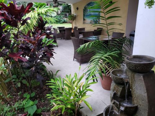 a patio with plants and a table and chairs at The Balboa Inn in Panama City
