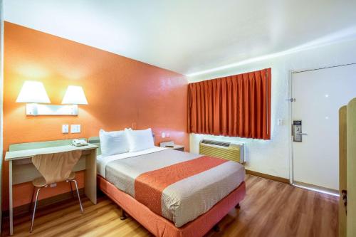 a hotel room with a bed and a desk at Motel 6-Youngtown, AZ - Phoenix - Sun City in Youngtown