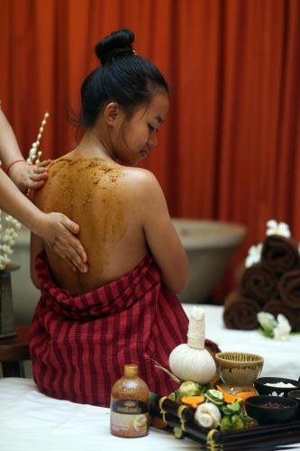 a woman with her back to a table with food at Central Corner d'Angkor in Siem Reap