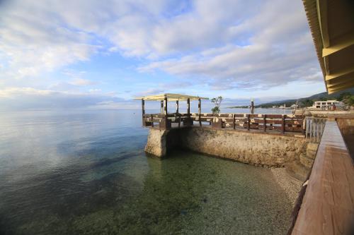 a view of a dock in the water at GingGing Hotel And Resort in Oslob