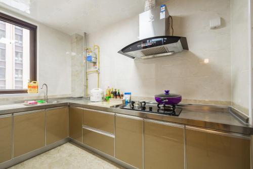 Η κουζίνα ή μικρή κουζίνα στο Zhengzhou Gaoxin·Zhengzhou University Subway Station· Locals Apartment 00149410
