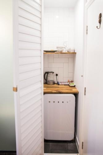 a small kitchen with white walls and a counter at Bayhaven Lodge in Byron Bay
