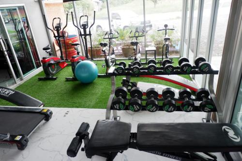 a gym with a bunch of exercise bikes in a room at Valee home & food in Nakhon Nayok