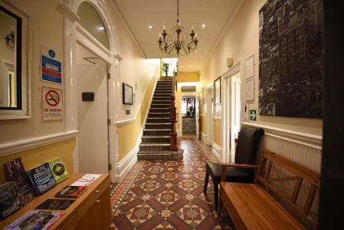 a staircase leading up to a living room filled with furniture at Victoria Park Hotel in Derby