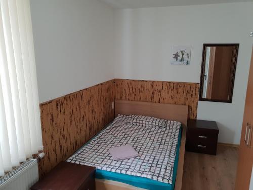 a small bed in a room with a wooden headboard at Pension Haus Baron 1 Neckarau in Mannheim
