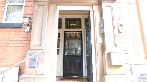 a doorway leading to a building with a door open at Victoria Park Hotel in Derby