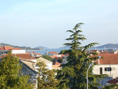 a view of a city with a tree at Apartments Jolić in Vodice