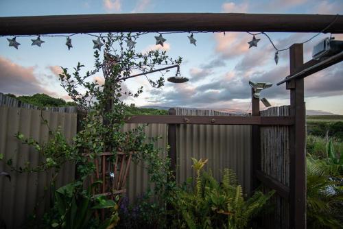 a garden with a fence and a fence at God's Peace of Maui in Makawao