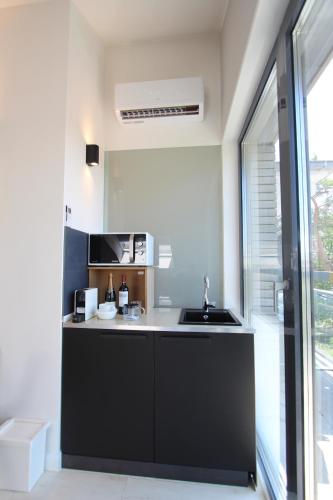 a small kitchen with a sink and a window at Loft am See mit privatem Badestrand und Klimaanlage in Immenstaad am Bodensee