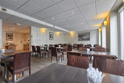 a dining room with wooden tables and chairs at Timhotel Opera Madeleine in Paris