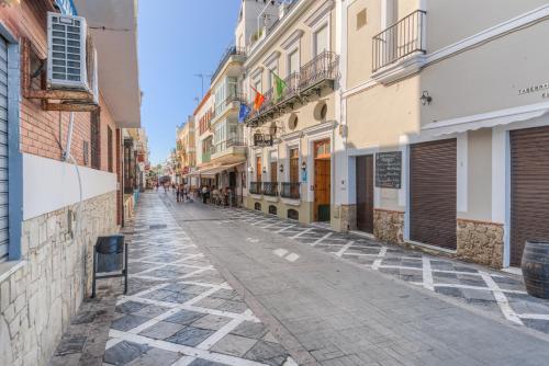 an empty street in a city with buildings at Hotel La Española in Chipiona