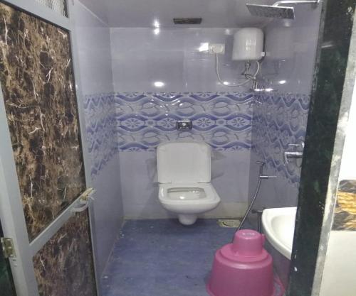 a small bathroom with a toilet and a sink at Ahlan Green Apple Dormitory in Mumbai