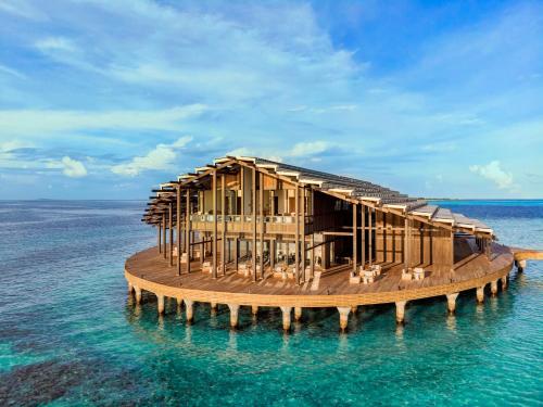 a house on a pier in the water at Kudadoo Maldives Private Island – Luxury All inclusive in Lhaviyani Atoll