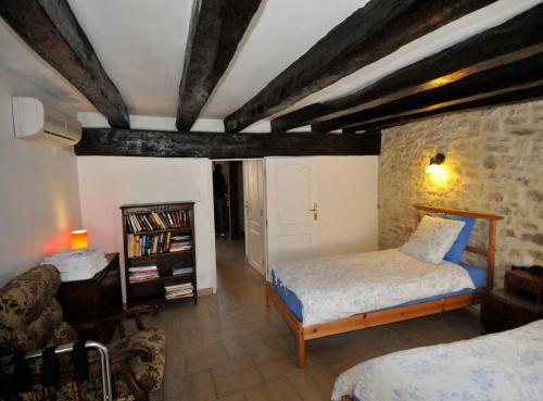a bedroom with a bed and a book shelf at Le Passage in La Charité-sur-Loire