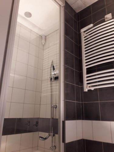 La salle de bains est pourvue d'une douche et d'une fenêtre. dans l'établissement Maison de village, à Bagnols-en-Forêt