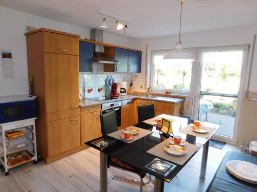 a kitchen with a table and a dining room at FEWO Traut in Wittlich
