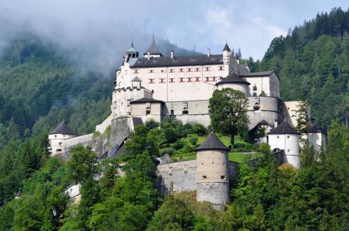 a large castle on top of a mountain at Ferienwohnung Saunahaus in Annaberg im Lammertal