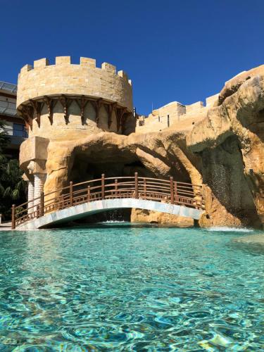 a bridge over the water in a water park at Dreamland oasis in Chakvi in Chakvi