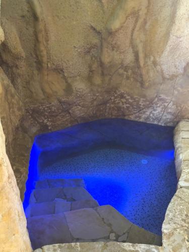 a blue swimming pool in a rock cave at Dreamland oasis in Chakvi in Chakvi
