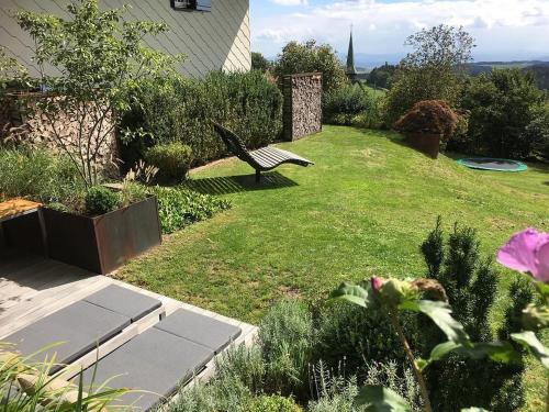 a garden with a bench in the grass at Landhausvilla Strittberg 7 in Höchenschwand