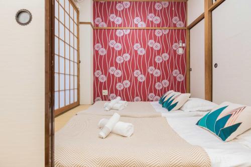 two beds in a room with two stuffed animals on them at Evergreen hotel ichigaya luxe in Tokyo