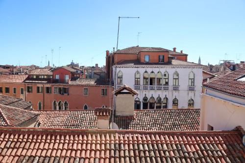 a view of a city from the roofs of buildings at Palazzo Vendramin Costa in Venice