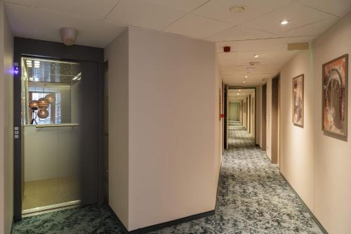 a corridor of an office building with a hallway at Hotel Memories Budapest in Budapest