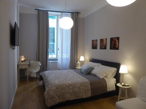 a bedroom with a bed and a table and a window at Covo Giulia in Genoa