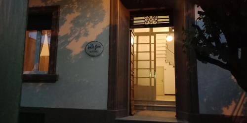 a door to a room with a clock on the wall at Villa Giove Rooms in Prato