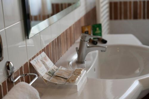 a bathroom sink with a faucet on a counter at Hotel Villa Venus Resort & SPA in Atena Lucana