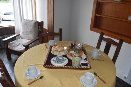 a table with a tray of food on it at Cabañas Del Lacar in San Martín de los Andes