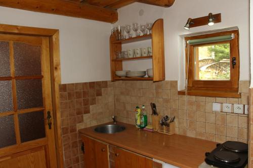 a kitchen counter with a sink and a window at Chata Donovaly Buly 242/C in Donovaly
