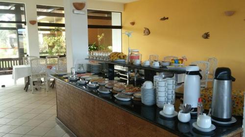 a buffet in a restaurant with food on a counter at Foz do Sauipe Eco Hotel in Porto de Sauipe