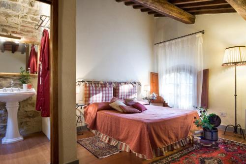 a bedroom with a bed and a sink at Tenuta Sant'Ilario in Gambassi Terme
