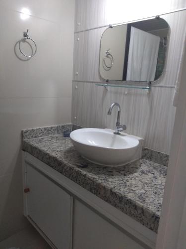a bathroom with a white sink and a mirror at Eco Paradise ap 122 in Cumbuco