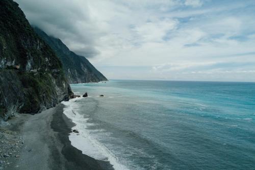 a view of a beach next to the ocean at Story Inn City in Hualien City