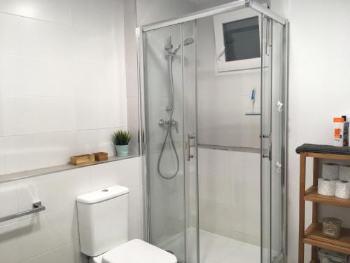 a bathroom with a toilet and a glass shower at KOA Centric, comfy in Ruzafa in Valencia