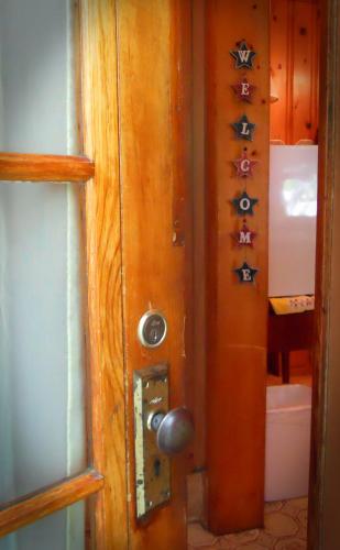 a door with signs on it in a bathroom at Little River Inn Motel in Leon