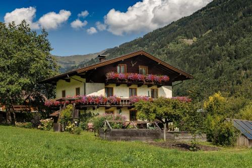 a house with flower boxes on the side of it at Haus Knapp FeWo Gastein in Dorfgastein
