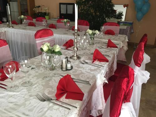 a set of tables with red napkins and silverware at Hotel San Giobbe in Giubiasco