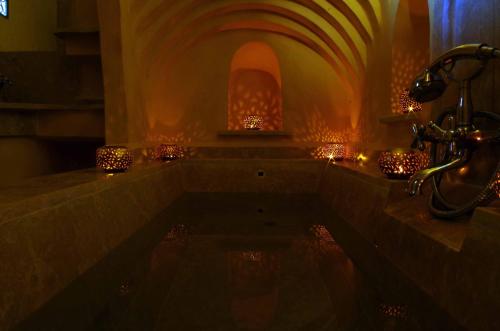 a bathroom with a tub with lights in it at Kasbah Titrit & Spa in Aït Ben Haddou