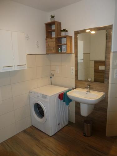 a washing machine and a sink in a bathroom at Memmert in Horumersiel