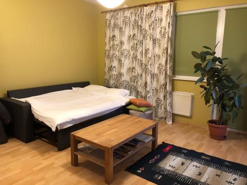 a small room with a bed and a table at Apartment near centre in Tartu