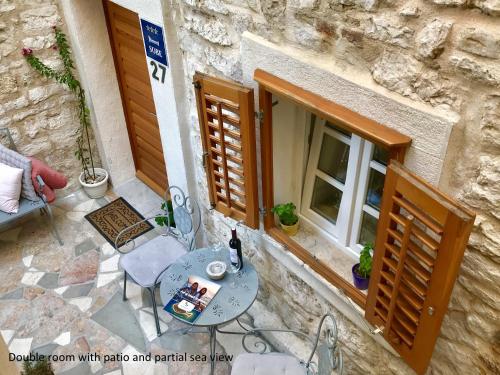 a table and chairs on a patio outside of a building at City Rooms Šibenik in Šibenik