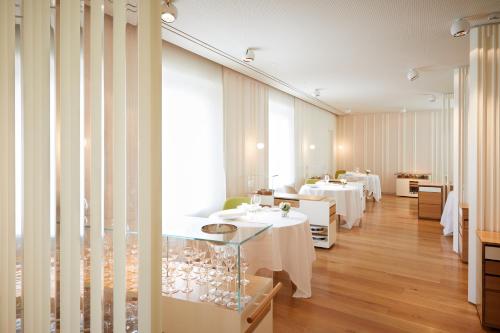 a restaurant with two tables with white tables at Hotel Echaurren Relais & Châteaux in Ezcaray