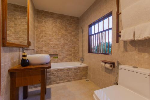 a bathroom with a sink and a bath tub at West Sands in Ukulhas