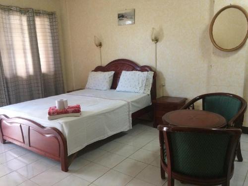 a bedroom with a bed and a table and a mirror at Sunrise Apartelle in Olongapo